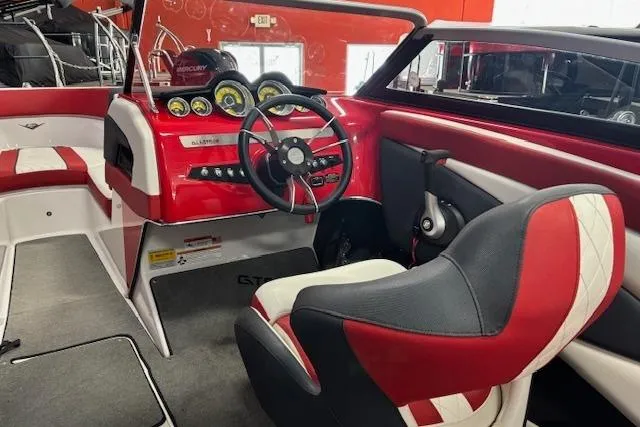 Slide: The Image of 2014 Glastron GTS 225 boat interior with red and white seating and dashboard. - 6
