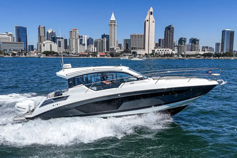 Slide: The Image of 2020 Four Winns Vista 355 Coupe OB cruising near city skyline. - 2