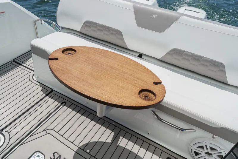 Slide: The Image of 2020 Four Winns Vista 355 Coupe OB boat interior with wooden table and cushioned seating. - 21