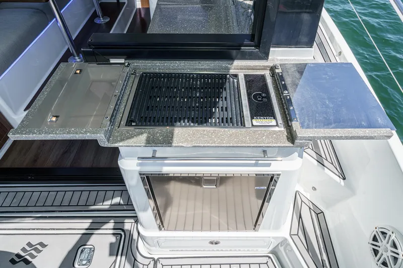Slide: The Image of Outdoor kitchen on 2020 Four Winns Vista 355 Coupe OB boat with grill and counter space. - 22