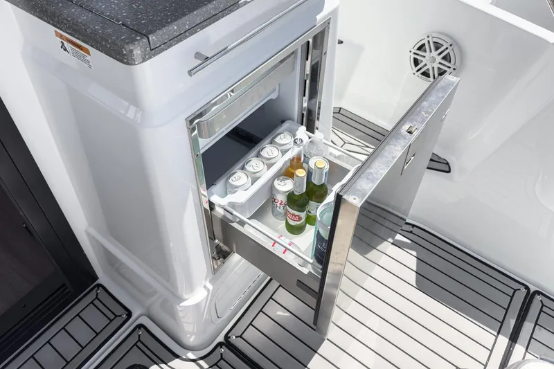 Slide: The Image of 2020 Four Winns Vista 355 Coupe OB boat with open beverage fridge. - 23