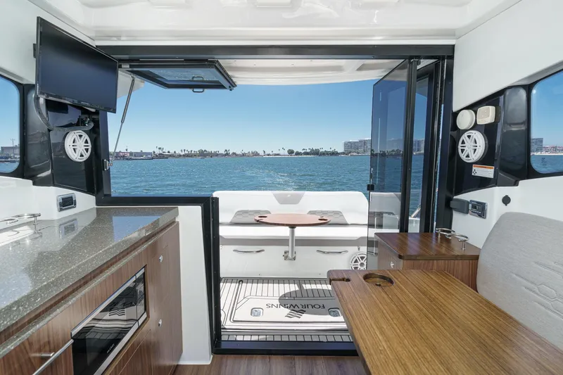 Slide: The Image of Interior view of 2020 Four Winns Vista 355 Coupe OB yacht with ocean backdrop. - 24