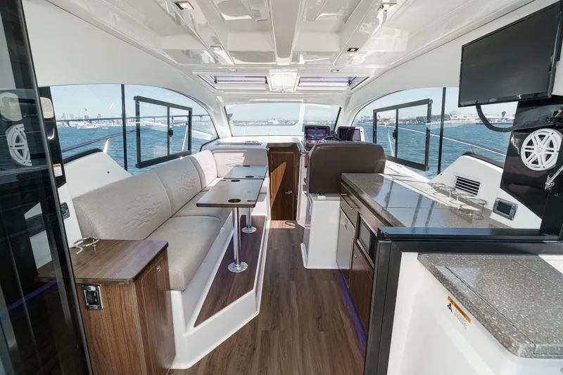 Slide: The Image of Interior of 2020 Four Winns Vista 355 Coupe OB, featuring modern seating and navigation area. - 25