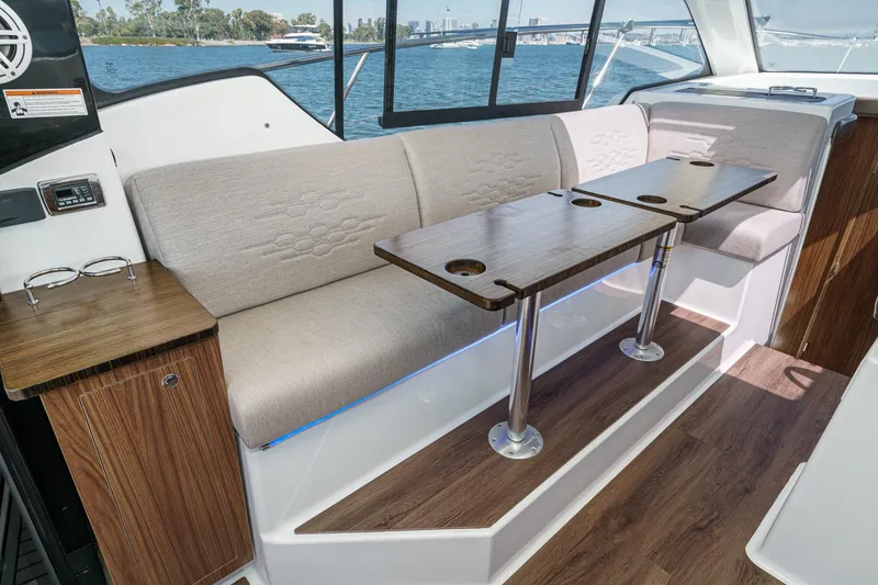 Slide: The Image of 2020 Four Winns Vista 355 Coupe OB interior with elegant seating and wooden table. - 26