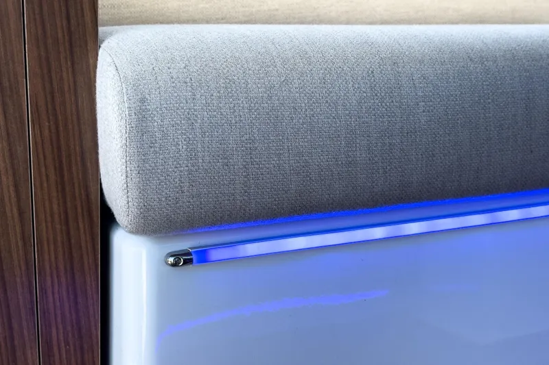 Slide: The Image of Cushioned interior detail with blue LED lighting on 2020 Four Winns Vista 355 Coupe OB. - 27