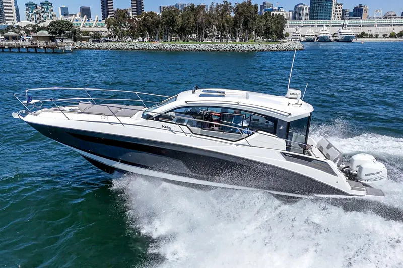 Slide: The Image of 2020 Four Winns Vista 355 Coupe OB cruising on water near city skyline. - 3