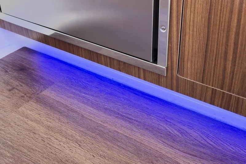 Slide: The Image of LED-lit wooden interior of 2020 Four Winns Vista 355 Coupe OB boat. - 32