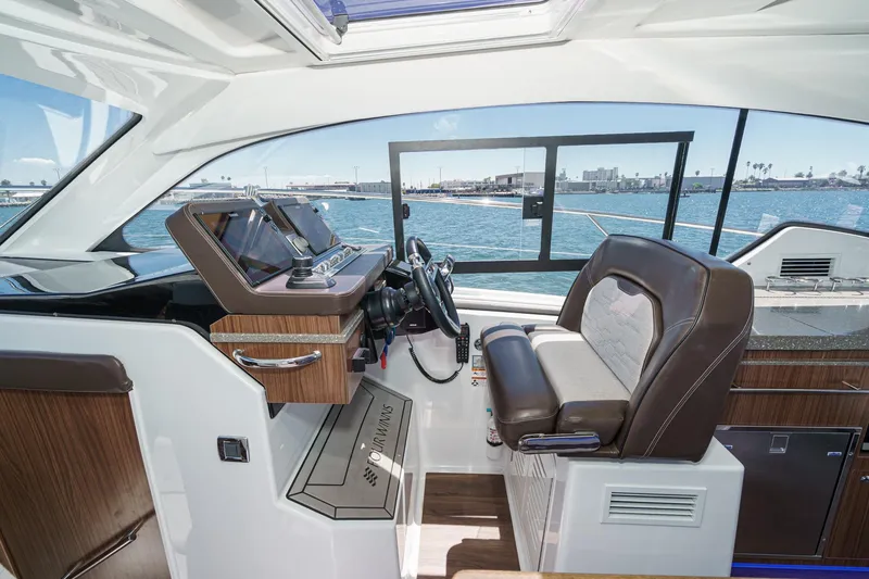 Slide: The Image of Interior of 2020 Four Winns Vista 355 Coupe OB, featuring modern helm and luxurious seating. - 33