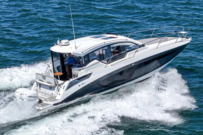 Slide: The Image of 2020 Four Winns Vista 355 Coupe OB cruising on open water, showcasing sleek design. - 4