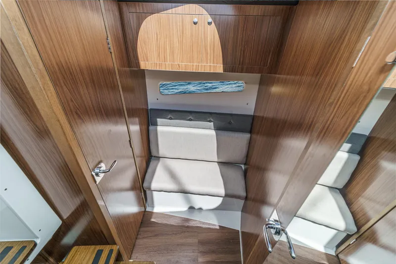 Slide: The Image of 2020 Four Winns Vista 355 Coupe OB cabin interior with wood finish and seating area. - 42