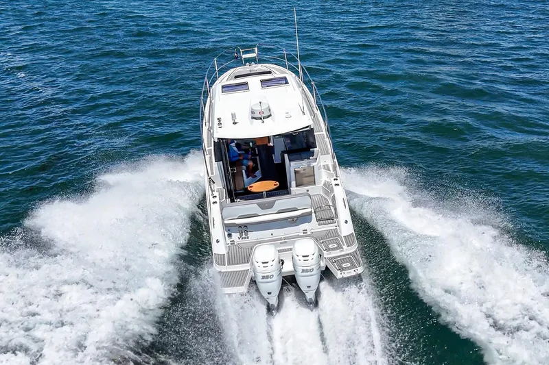 Slide: The Image of 2020 Four Winns Vista 355 Coupe OB cruising on open water, rear view. - 5