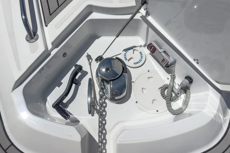 Slide: The Image of Anchor compartment of 2020 Four Winns Vista 355 Coupe OB with chain and controls. - 57