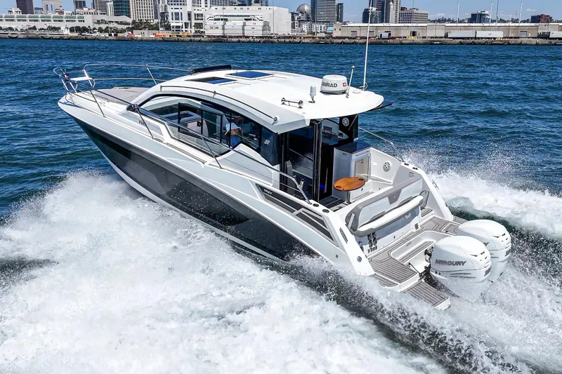 Slide: The Image of 2020 Four Winns Vista 355 Coupe OB cruising on water near city skyline. - 6