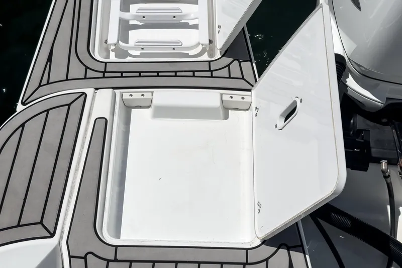 Slide: The Image of 2020 Four Winns Vista 355 Coupe OB boat storage compartments open on deck. - 63