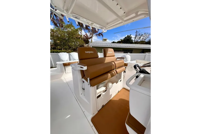 Slide: The Image of 2013 Everglades 325 Center Console boat interior with brown seating and white deck. - 17