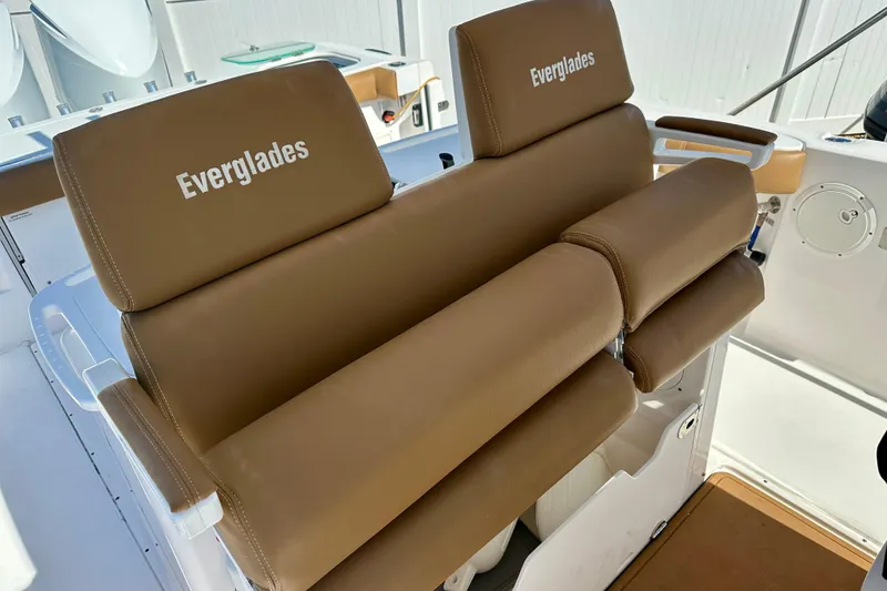 Slide: The Image of 2013 Everglades 325 Center Console boat seating with brown cushions and Everglades branding. - 18