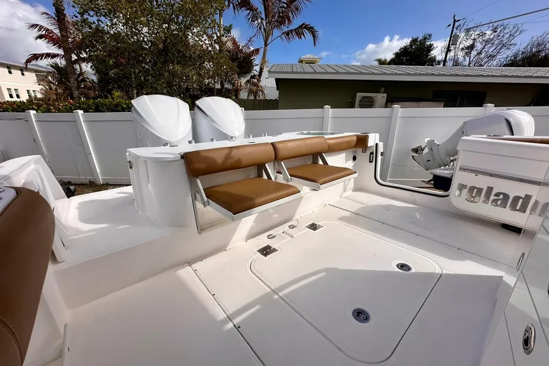 Slide: The Image of 2013 Everglades 325 Center Console boat with tan seating and white deck. - 21
