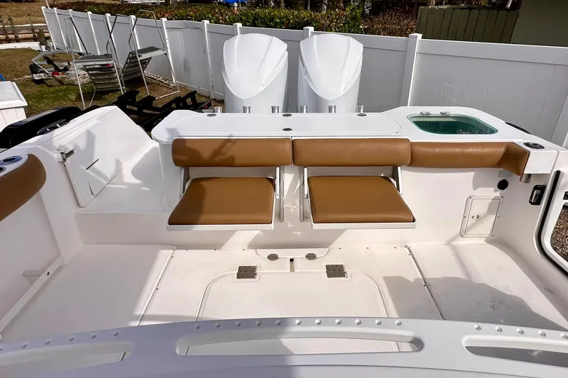Slide: The Image of 2013 Everglades 325 Center Console boat interior with tan seating and white deck. - 22