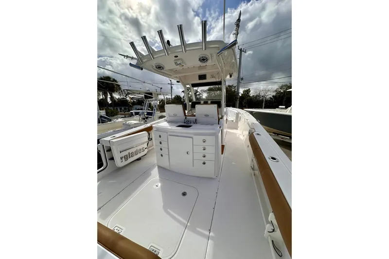 Slide: The Image of 2013 Everglades 325 Center Console boat with sleek design and spacious deck. - 23