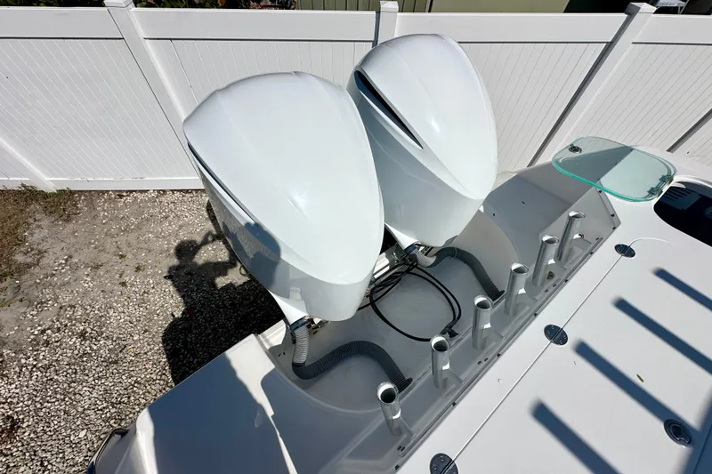 Slide: The Image of 2013 Everglades 325 Center Console boat interior with tan seating and table. - 8