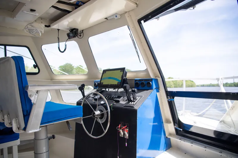 Slide: The Image of Interior of 2023 Smoky Mountain asymmetrical foil-assisted catamaran, featuring modern navigation controls. - 20