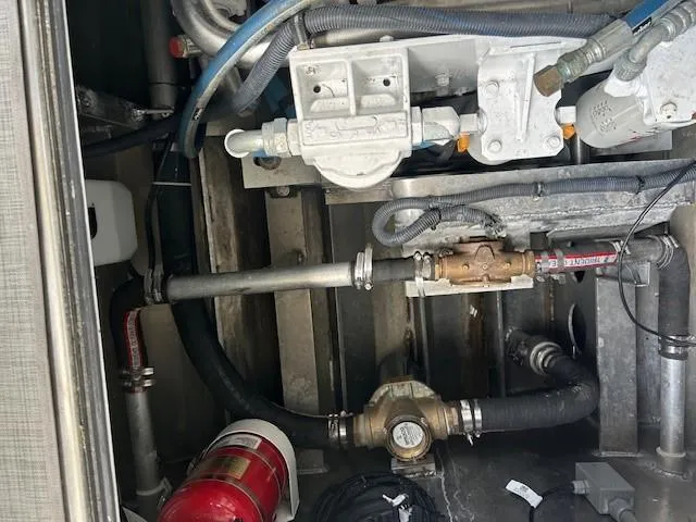 Slide: The Image of Engine compartment of 2023 Smoky Mountain asymmetrical foil-assisted catamaran, showing mechanical components and fire extinguisher. - 13