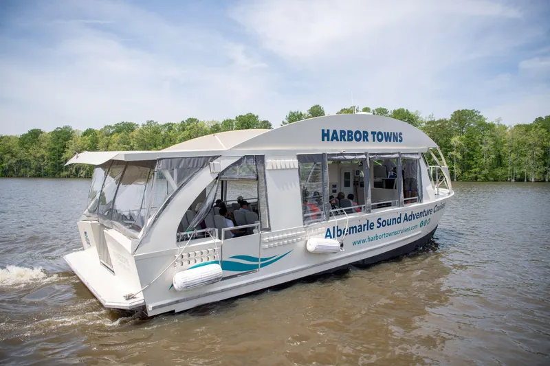 Slide: The Image of 2023 Smoky Mountain asymmetrical foil-assisted catamaran cruising on a scenic river. - 2