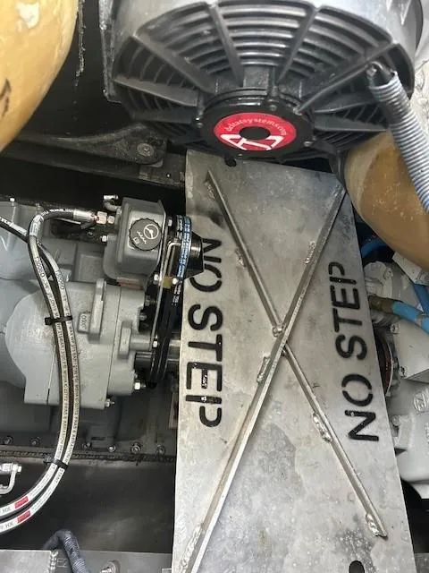 Slide: The Image of Engine compartment of 2023 Smoky Mountain catamaran with "No Step" warning sign. - 16