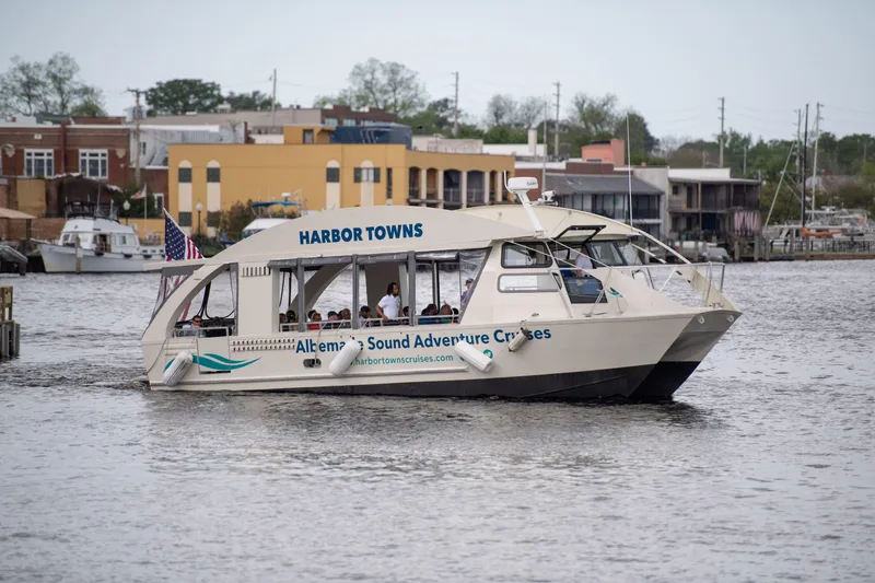 Slide: The Image of 2023 Smoky Mountain asymmetrical foil-assisted catamaran cruising in a harbor setting. - 1