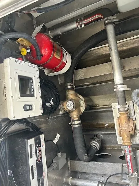 Slide: The Image of Engine compartment of 2023 Smoky Mountain catamaran with fire extinguisher and control panel. - 8