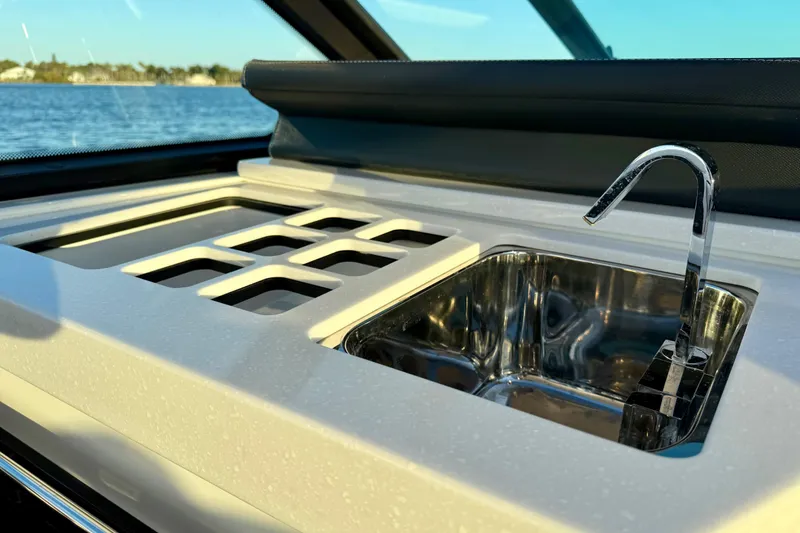 Slide: The Image of 2022 Monterey 385SS Super Sport boat sink and countertop detail by the water. - 13