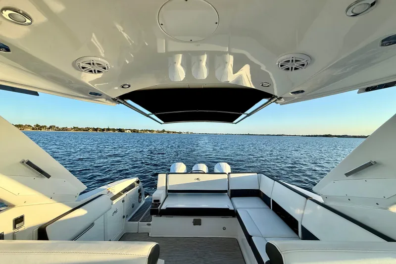 Slide: The Image of 2022 Monterey 385SS Super Sport boat interior with lake view, featuring sleek seating and modern design. - 14