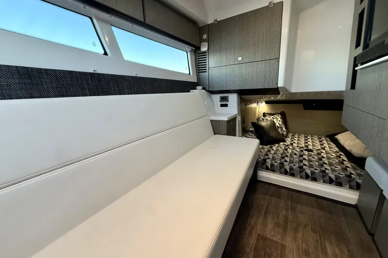 Slide: The Image of Interior of 2022 Monterey 385SS Super Sport boat with modern seating and bedding. - 25
