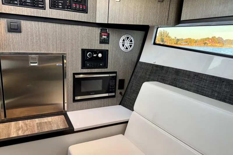 Slide: The Image of 2022 Monterey 385SS Super Sport interior with microwave, fridge, and control panel. - 26