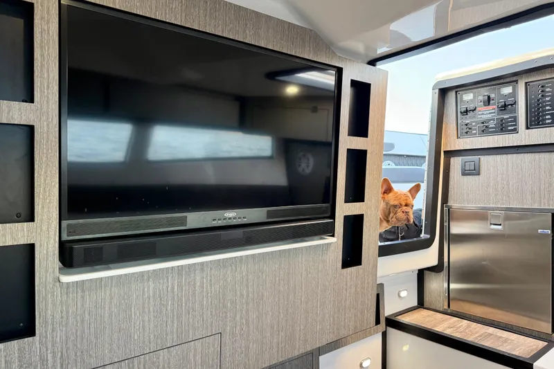 Slide: The Image of Interior of 2022 Monterey 385SS Super Sport with TV and curious dog peeking in. - 27