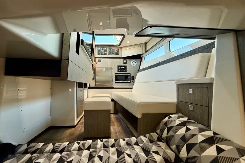 Slide: The Image of Interior of 2022 Monterey 385SS Super Sport boat, featuring modern seating and cabinetry. - 31