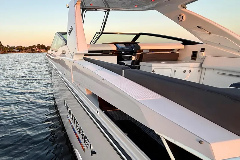 Slide: The Image of 2022 Monterey 385SS Super Sport boat on calm water at sunset. - 36