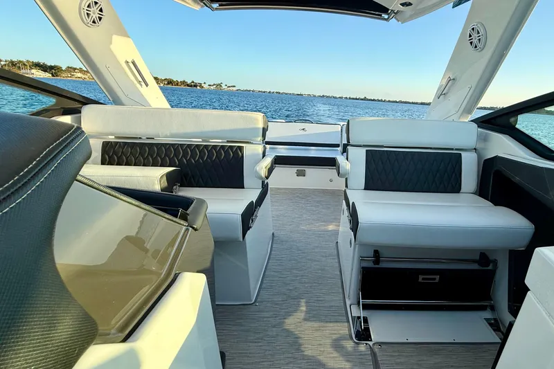 Slide: The Image of 2022 Monterey 385SS Super Sport boat interior with luxurious seating and scenic water view. - 9