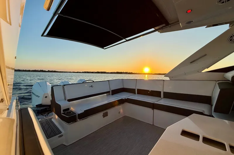 Slide: The Image of 2022 Monterey 385SS Super Sport boat interior at sunset on the water. - 18