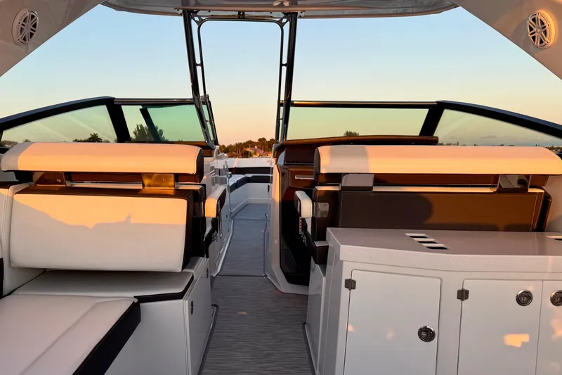 Slide: The Image of Interior of 2022 Monterey 385SS Super Sport boat at sunset, featuring luxurious seating. - 20