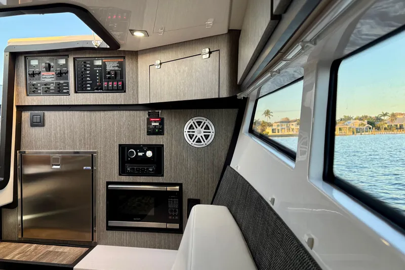 Slide: The Image of Interior of 2022 Monterey 385SS Super Sport boat with modern amenities and waterfront view. - 24