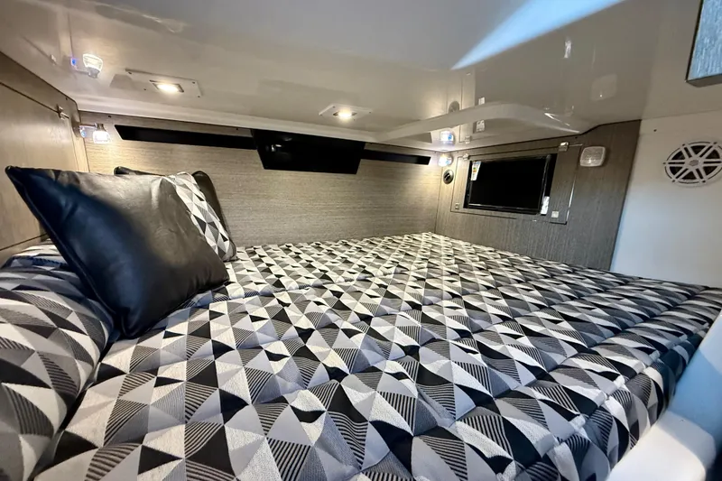 Slide: The Image of Luxurious cabin interior of 2022 Monterey 385SS Super Sport with geometric bedding design. - 29