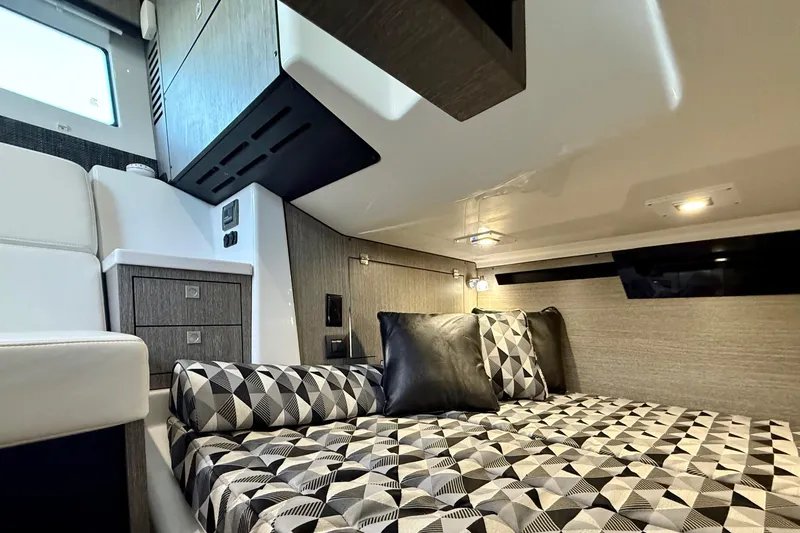 Slide: The Image of Luxurious interior cabin of 2022 Monterey 385SS Super Sport boat with geometric bedding. - 30