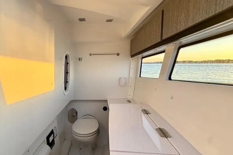 Slide: The Image of Interior of 2022 Monterey 385SS Super Sport boat with bathroom and scenic window view. - 32