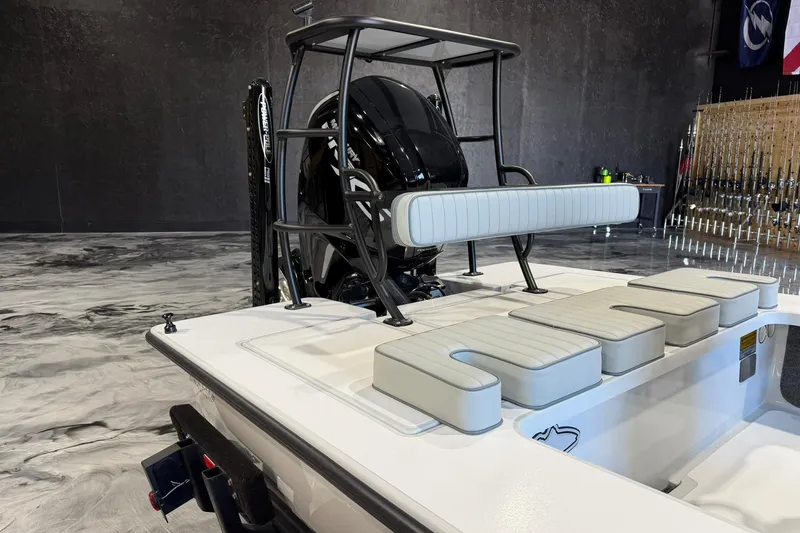 Slide: The Image of 2026 Hell's Bay Marquesa boat interior with seating and motor, displayed indoors. - 7