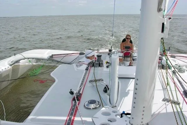 Slide: The Image of Sailing on a 2012 Hughes 40 catamaran with two people on deck. - 11