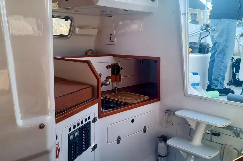 Slide: The Image of Interior of a 2012 Hughes 40 sailboat featuring a compact kitchen area. - 16