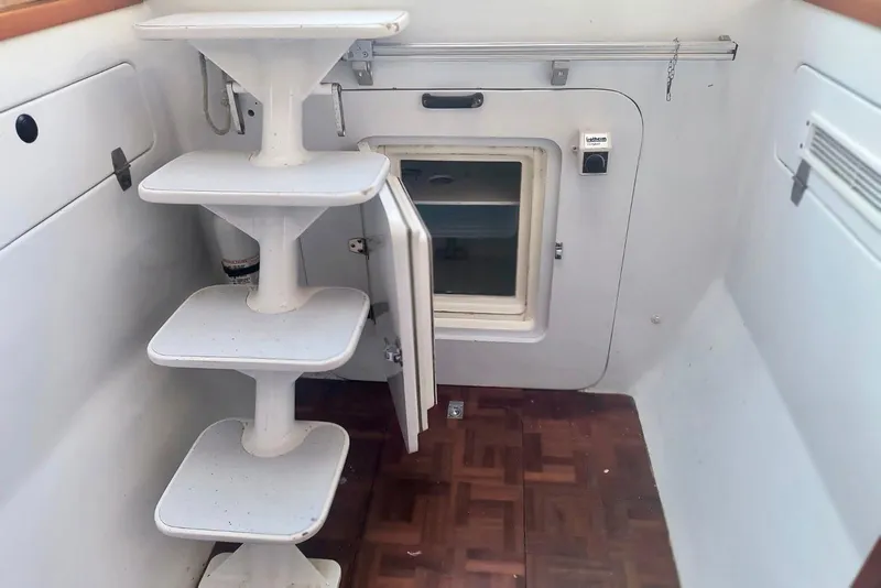 Slide: The Image of Interior of 2012 Hughes 40 boat with white steps and wooden floor. - 23