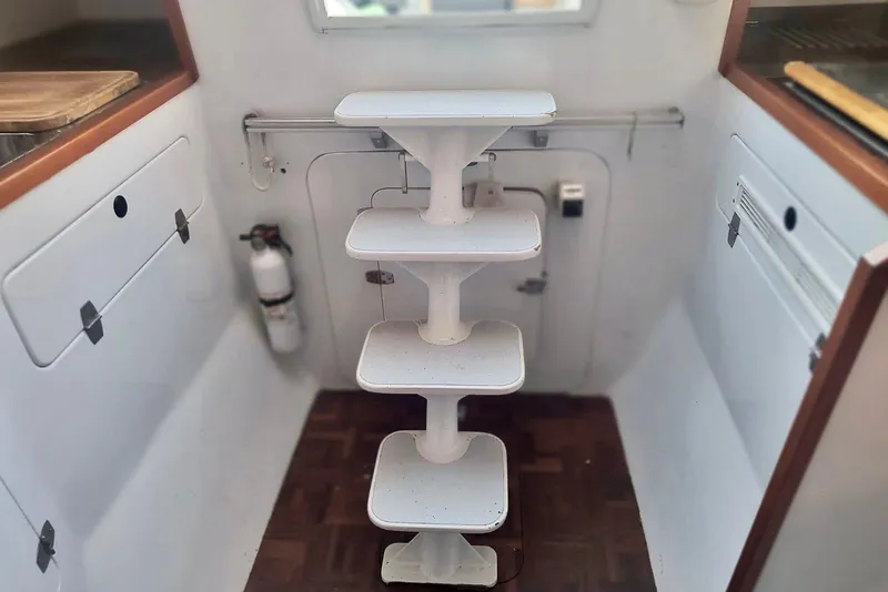 Slide: The Image of Interior of 2012 Hughes 40 boat with white staircase and wooden flooring. - 24