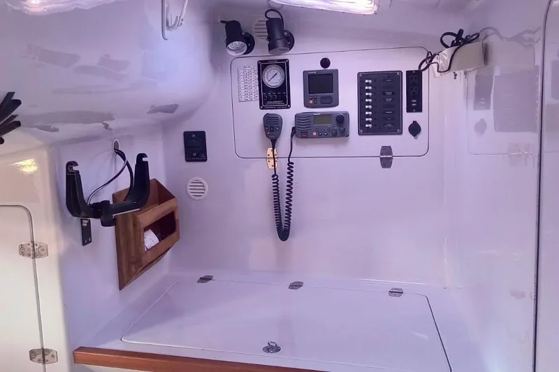 Slide: The Image of Control panel inside a 2012 Hughes 40 boat, featuring navigation and communication equipment. - 27